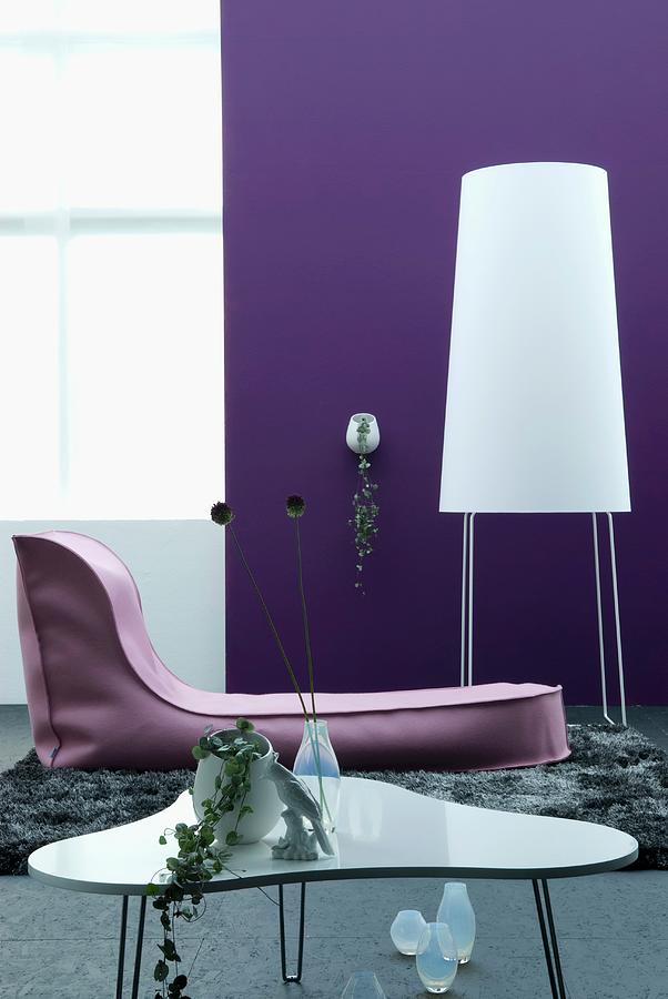 Contemporary Living Room With Designer Coffee Table, Couch And Standard Lamp Against Purple Wall Photograph by Matteo Manduzio