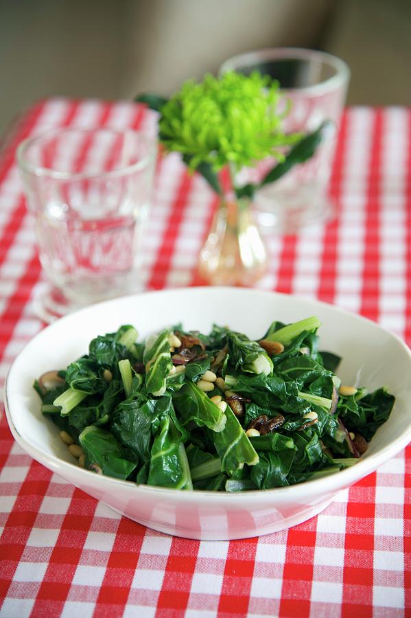 Cooked Chard With Pine Nuts And Raisins Photograph by Heinze, Winfried