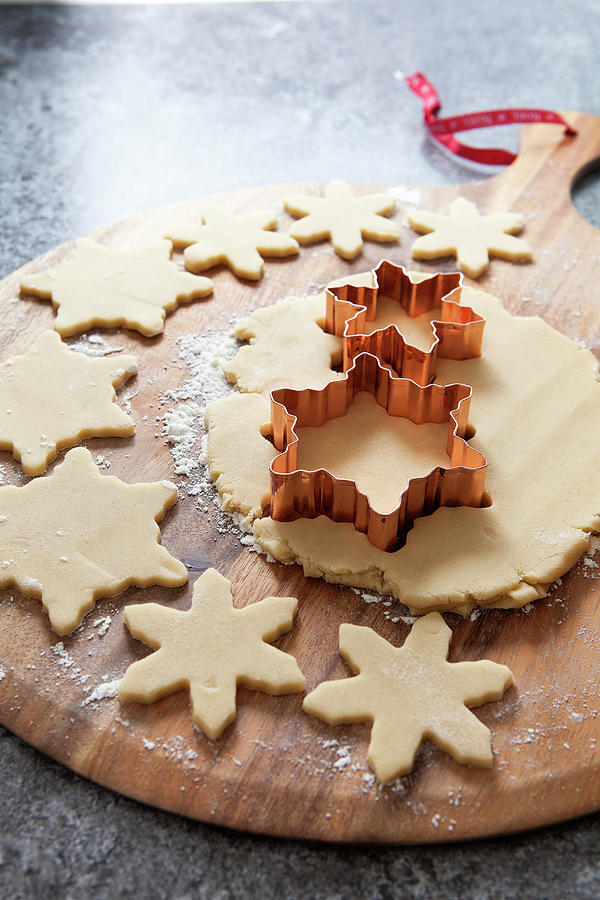 Cookie Dough Rolled Out Being Cut Out With A Copper Snowflake Shaped Cookie Cutter Photograph by Stacy Grant