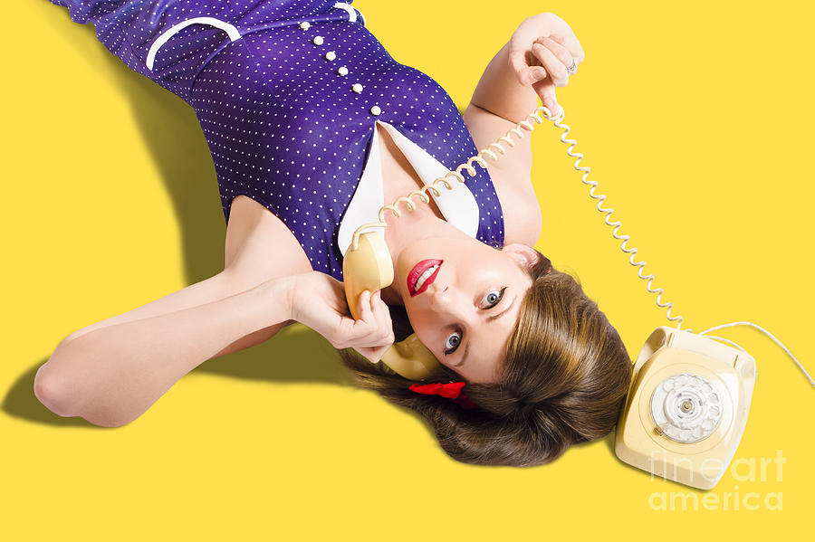 Cool pin-up girl making conversation on telephone Photograph by Jorgo Photography