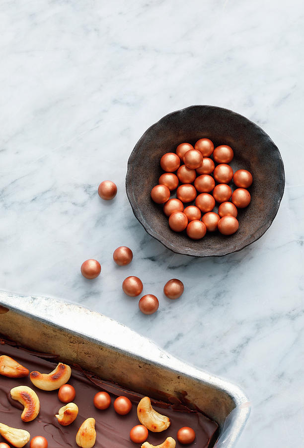 Copper-coloured Chocolate Balls As Decoration For Confectionery Photograph by Mathias Stockfood Studios / Neubauer