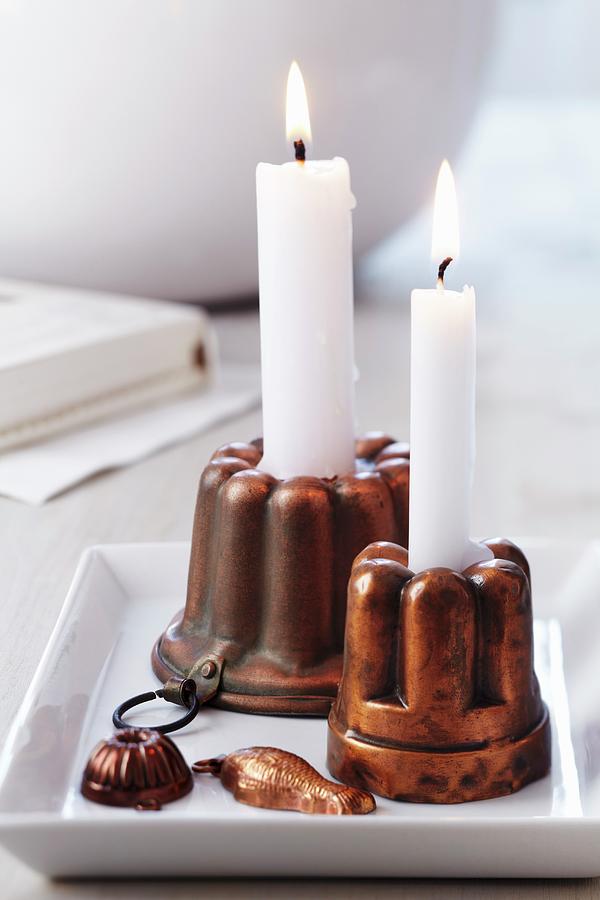 Copper Jelly Moulds Used As Candlesticks Photograph by Franziska Taube