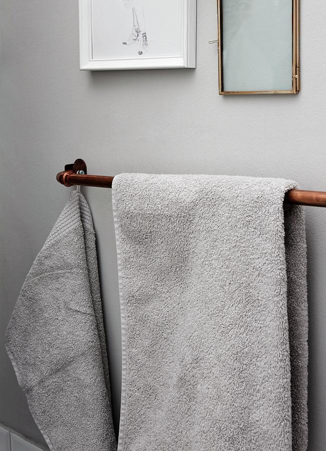 Copper Piping Used As Towel Rail Mounted On Wall Photograph by Nina Struve