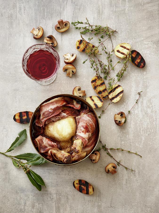 Coq Au Vin With Grilled Potato Halves, Mushrooms, Thyme, And A Glass Of Red Wine Photograph by Julia Hildebrand