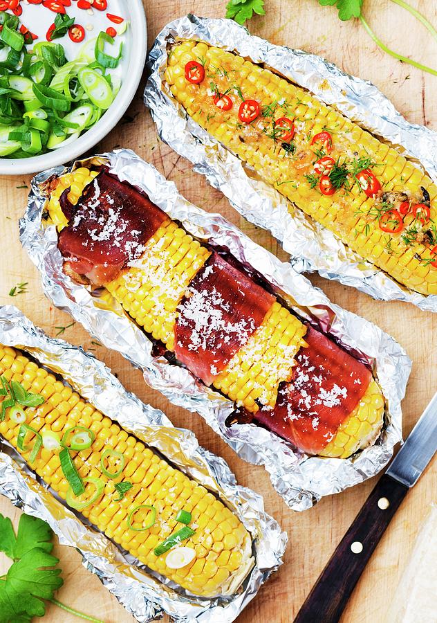 Corn Cobs With Parma Ham, Parmesan, Spring Onions And Sliced Chillies, In Aluminium Foil Photograph by Komar