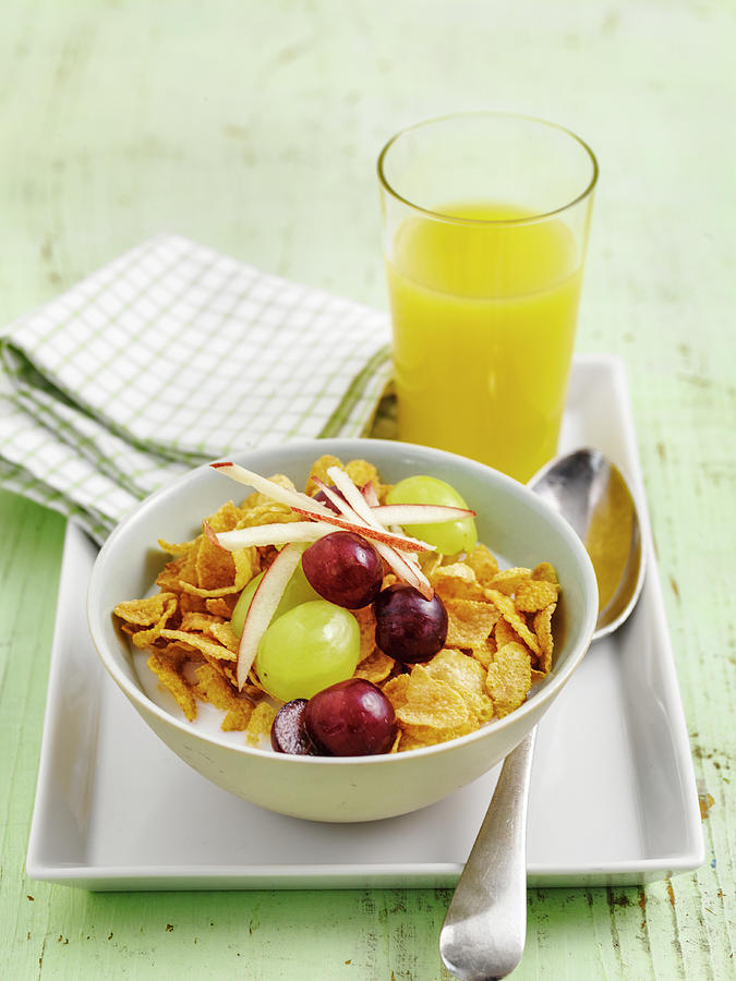 Cornflakes, Grapes And Shredded Apple With Orange Juice Photograph by Michael Paul