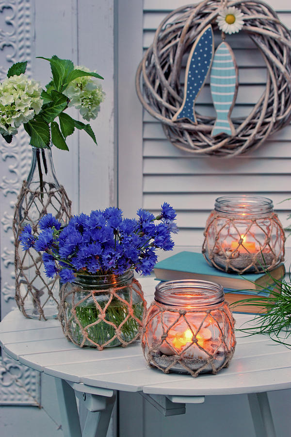 Cornflowers, Hydrangeas And Candle Lanterns On Garden Table Photograph by Angelica Linnhoff