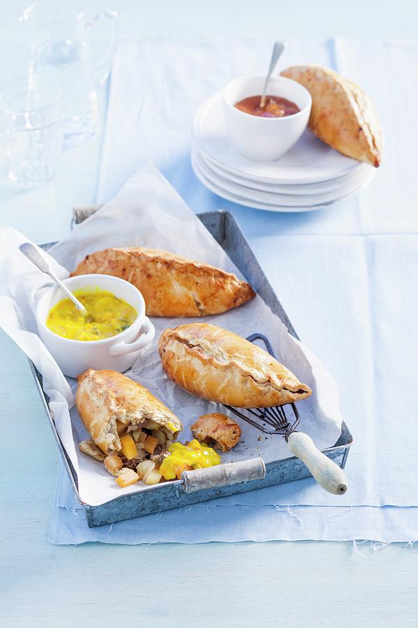 Cornish Pasties With Beef And Vegetables, Served With Piccalilly Chutney england Photograph by Peter Kooijman