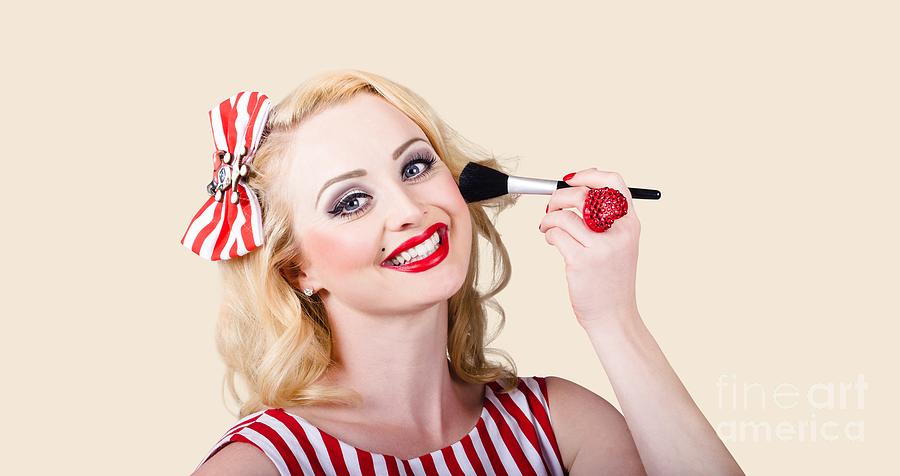 Cosmetics pin-up model applying blusher makeup Photograph by Jorgo Photography