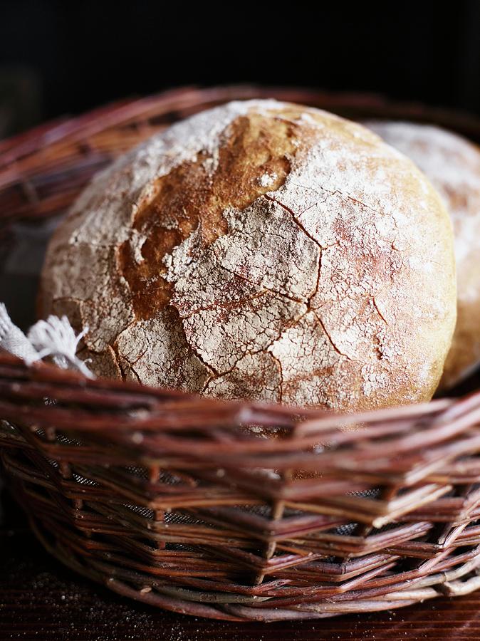 Country Bread In A Wicker Basket Photograph by Oliver Brachat