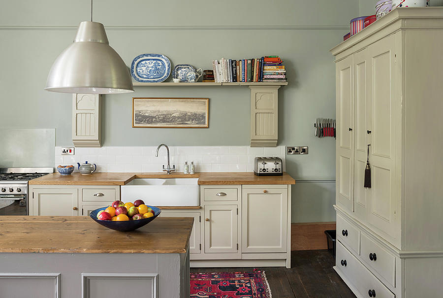 Country-house Kitchen With Beige Panelled Cupboards And Island Counter Photograph by Brian Harrison