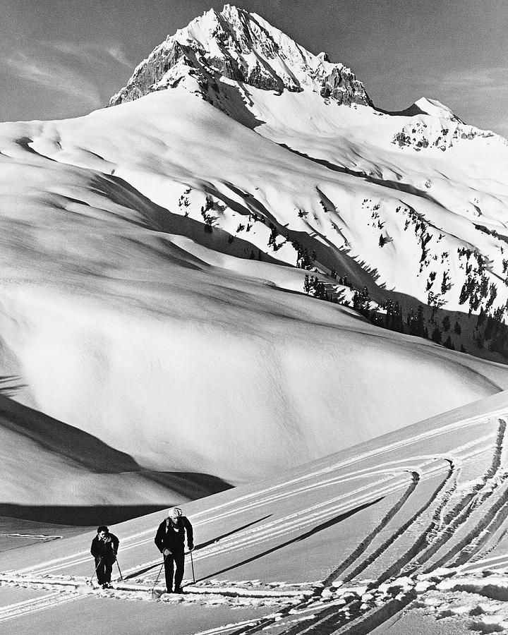 Couple Cross-country Skiing In Mountains Photograph by Stockbyte