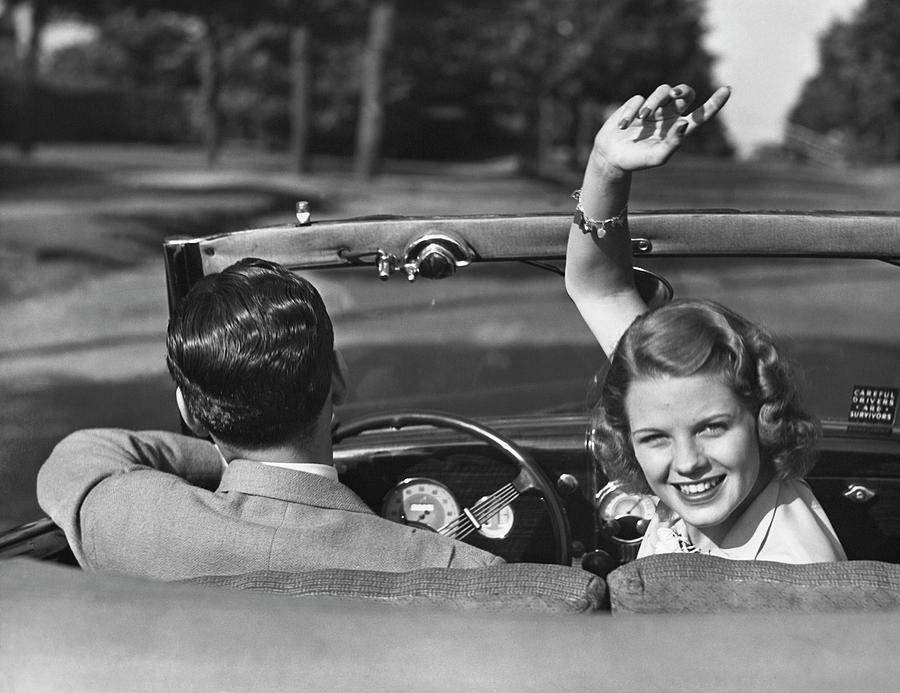Couple Driving In Convertible Photograph by George Marks