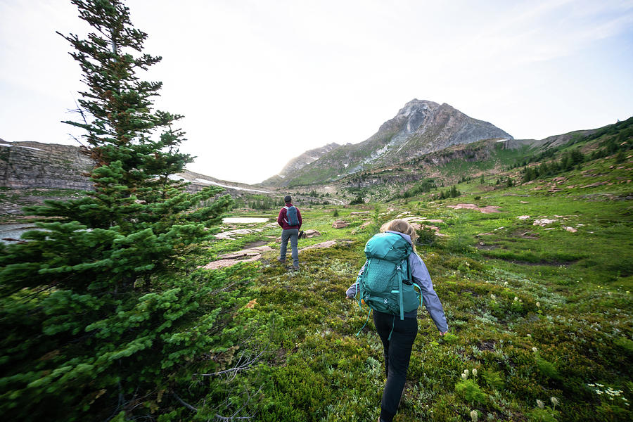 Couple Hiking Together Into The Sunset At Height Of The Rockies