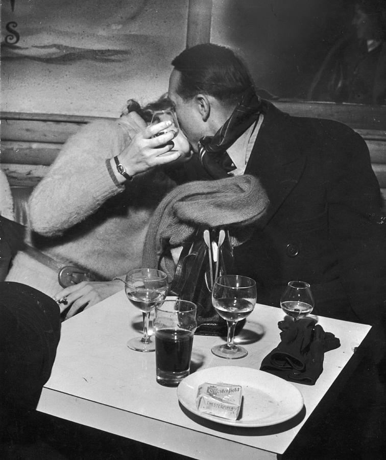 Black And White Photograph - Couple Kiss In Cafe by David E. Scherman