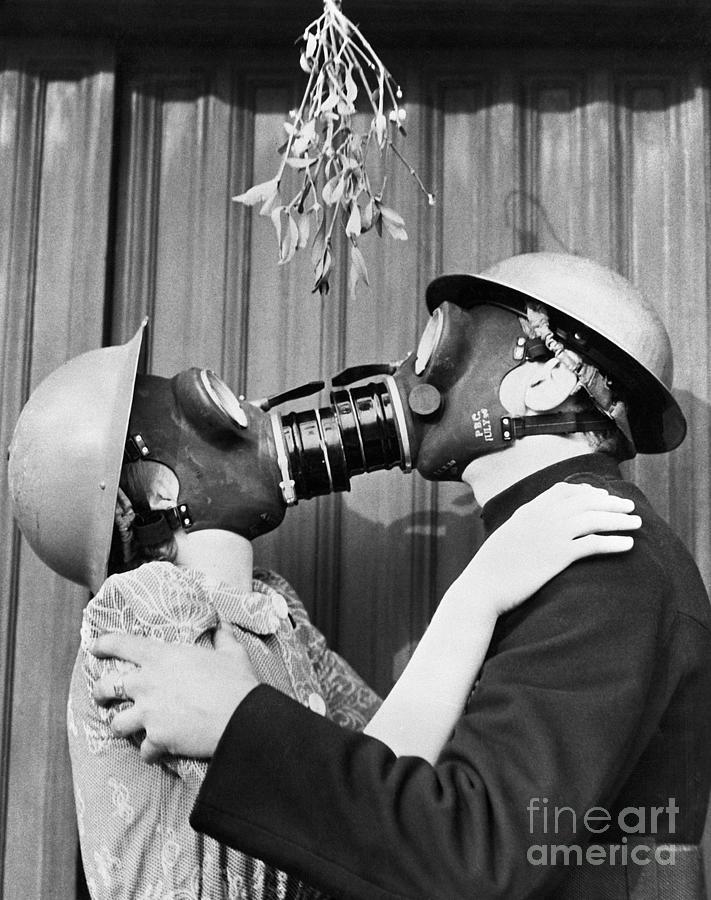 Couple Kissing Through Gas Masks Photograph by Bettmann