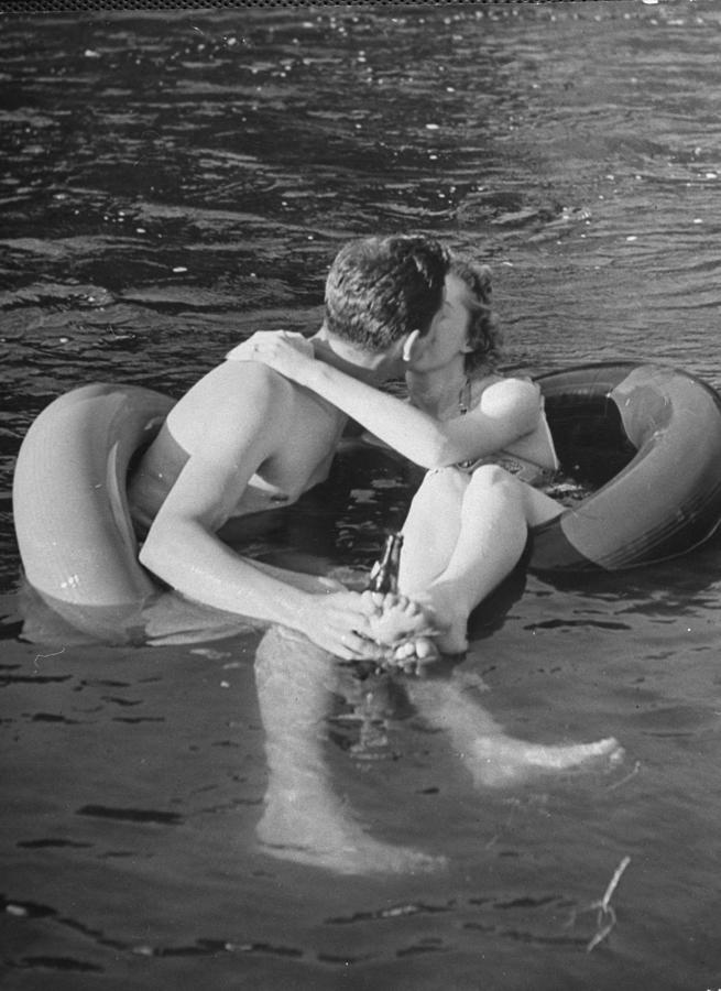 Couple Kissing While Innertube Floating Photograph by Alfred Eisenstaedt Couple Kissing While Innertube Floating Photograph by Alfred Eisenstaedt