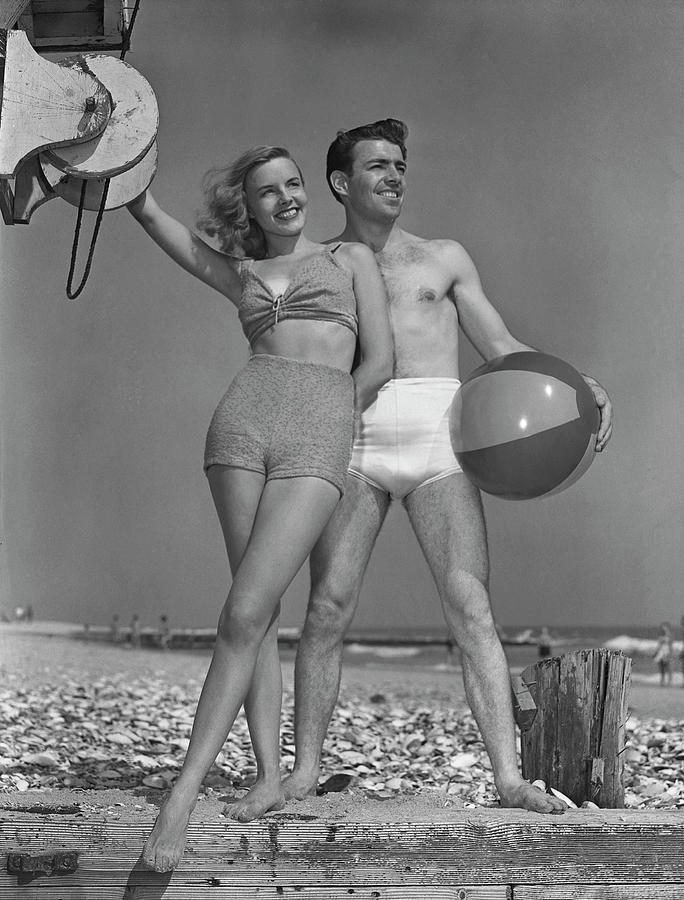 Couple On Beach Wbeach Ball Photograph by George Marks