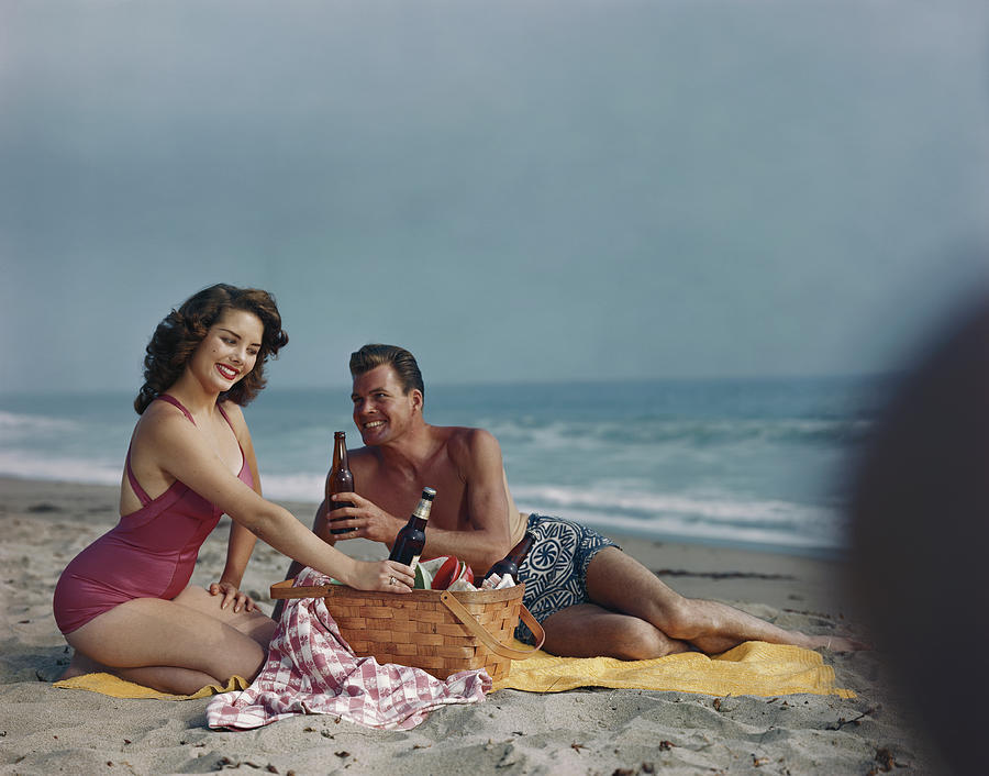 Couple Sitting On Beach Holding Beer Photograph by Tom Kelley Archive