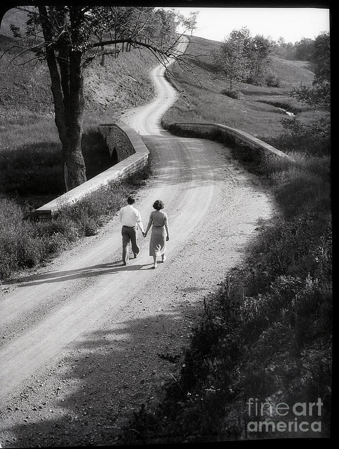 Couple Walking Along Rural Road Photograph by Bettmann