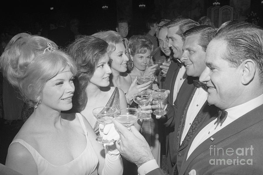 Couples Making A Toast With Drinks by Bettmann