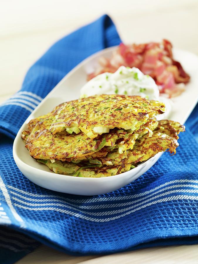 Courgette And Carrot Pancakes With Quark And Bacon Photograph by Studio R. Schmitz