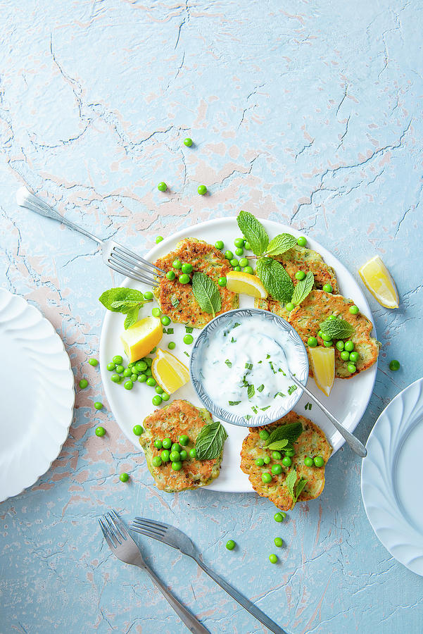 Courgette And Pea Fritters With Lemon And Minted Yoghurt Dip Photograph by Magdalena Hendey