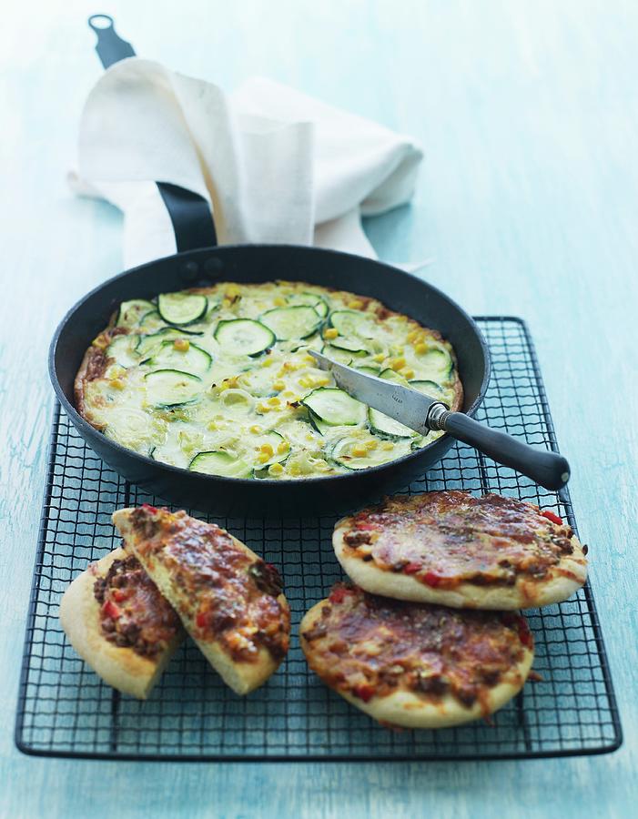 Courgette And Sweetcorn Omelette And Mini Pizzas With Beef And Peppers Photograph by Mikkel Adsbl