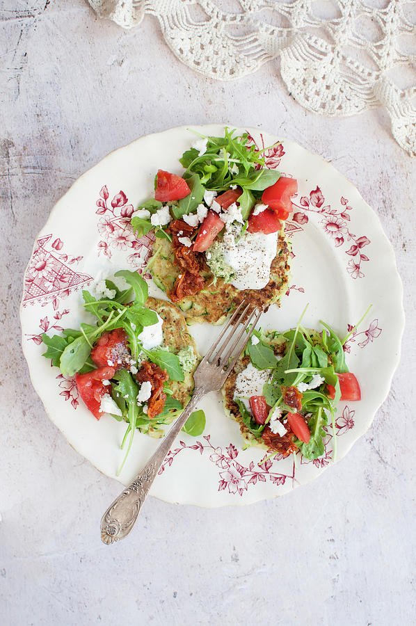 Courgette Cakes Topped With Cream, Tomato, Arugula And Feta Cheese Photograph by Kachel Katarzyna