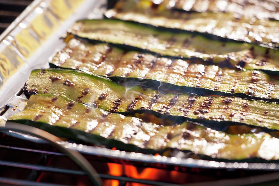Courgette Strips In An Aluminium Tray On A Barbecue Photograph by Studio Lipov