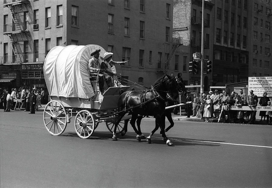 Covered Wagon On Street During Parade Photograph by George Marks