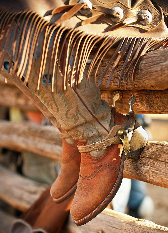 Cowboy Boots On Fence Photograph by Tetra Images