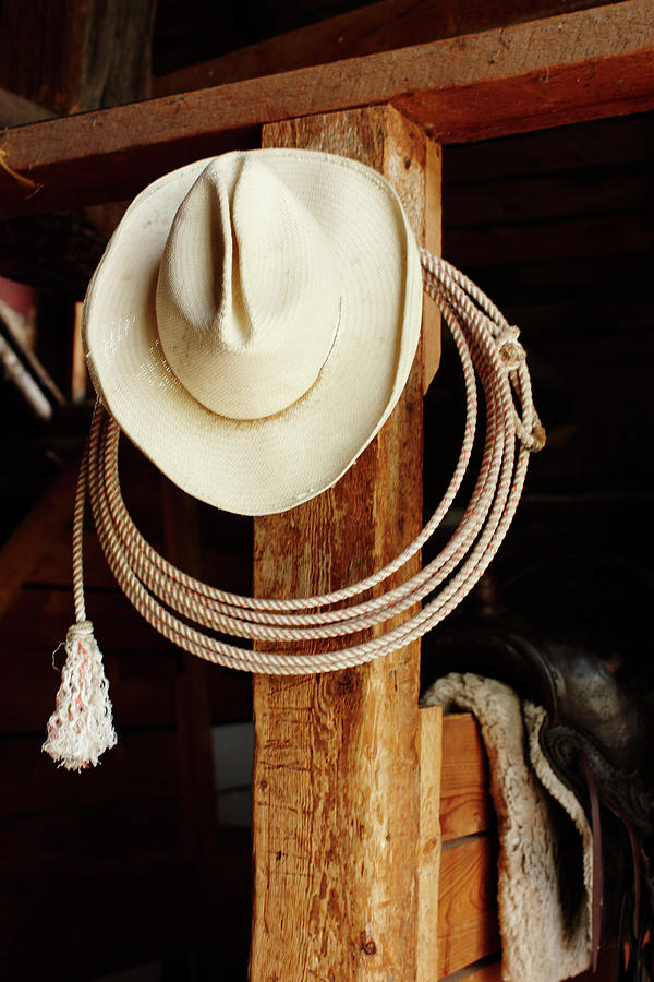 Cowboy Hat Hanging In Barn With Rope Photograph by Nash Photos