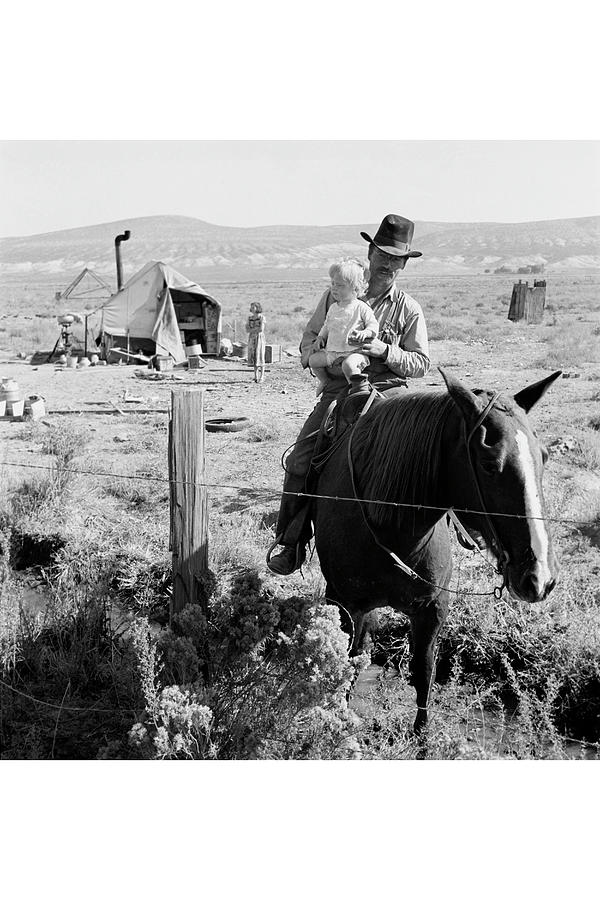 Cowboy holds his baby while riding a horse Painting by Dorothea Lange