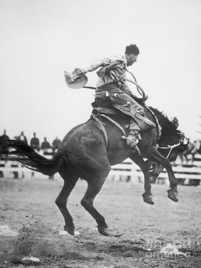 Cowboy Riding Horse In Rodeo Photograph by Bettmann