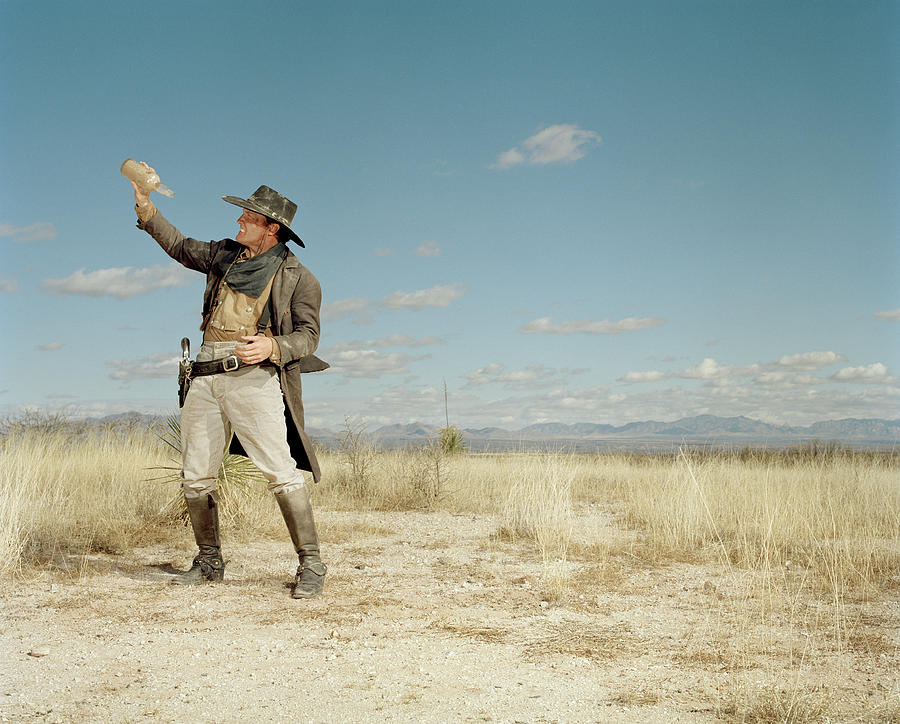 Cowboy Standing In Desert With Empty Photograph by Matthias Clamer
