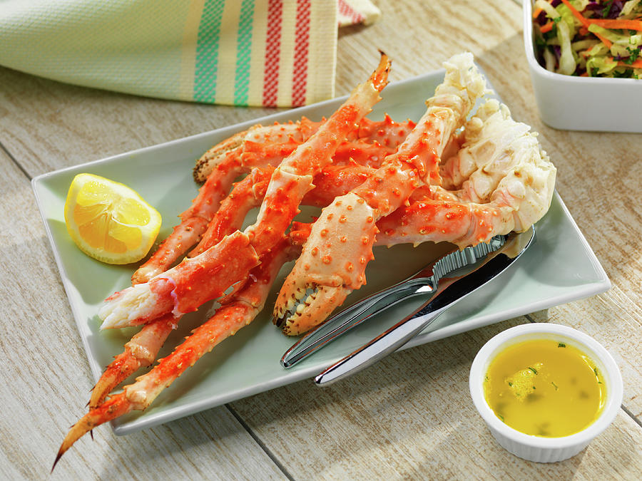 Crab Legs With Butter And Lemons Photograph by Jim Scherer
