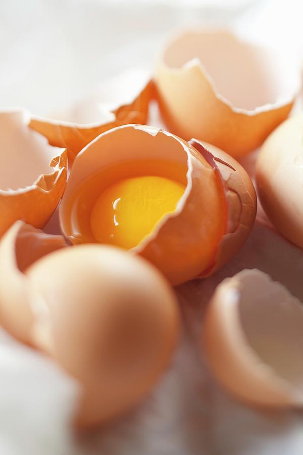 Cracked Egg Shells With Egg Yolk In Shell Photograph by Jon Edwards Photography