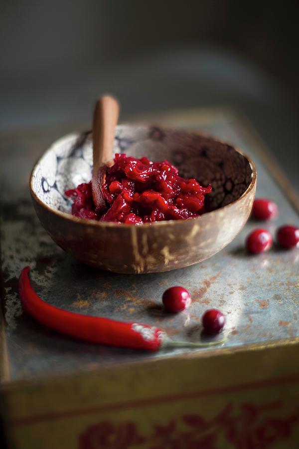 Cranberry And Chilli Chutney In A Bowl Photograph by Sabine Lscher