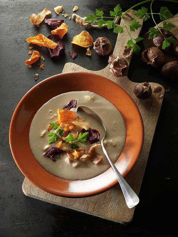 Cream Of Chestnut Soup With Vegetables Chips And Parsley Photograph by Ludger Rose