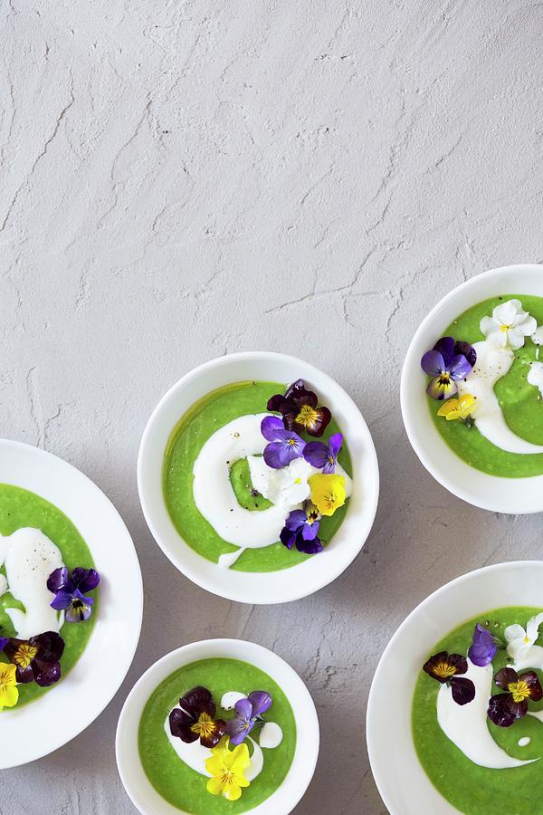 Cream Of Green Pea Soup With Sour Cream And Edible Flowers Photograph by Malgorzata Laniak