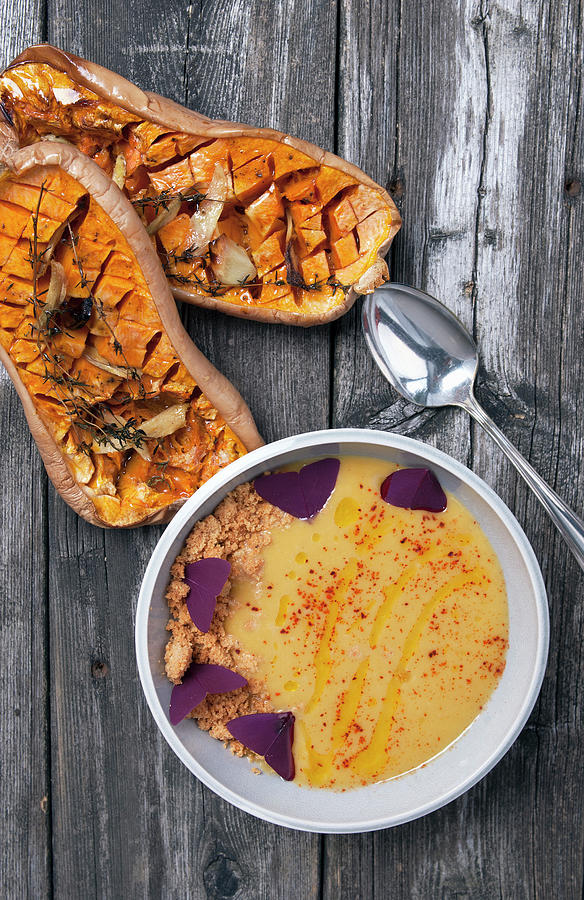Cream Of Pumpkin Soup With Breadcrumbs And Edible Flowers, And Oven-baked Pumpkin With Thyme And Garlic Photograph by Spyros Bourboulis