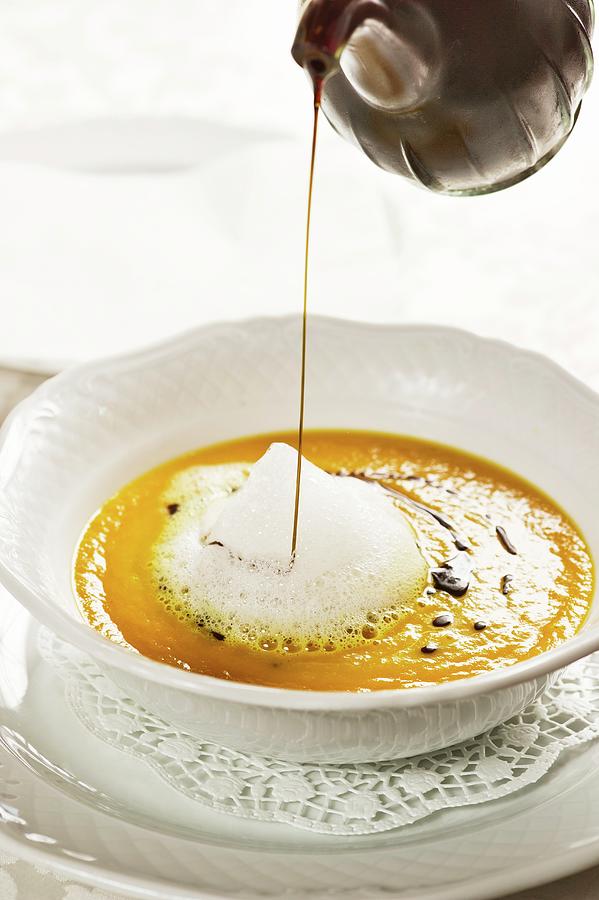 Cream Of Pumpkin Soup With Pumpkin Seed Oil Photograph by Rita Newman