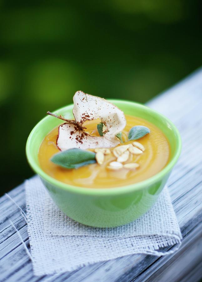 Cream Of Squash Soup With Apple Crisps And Pumpkin Seeds Photograph by Strokin, Yelena