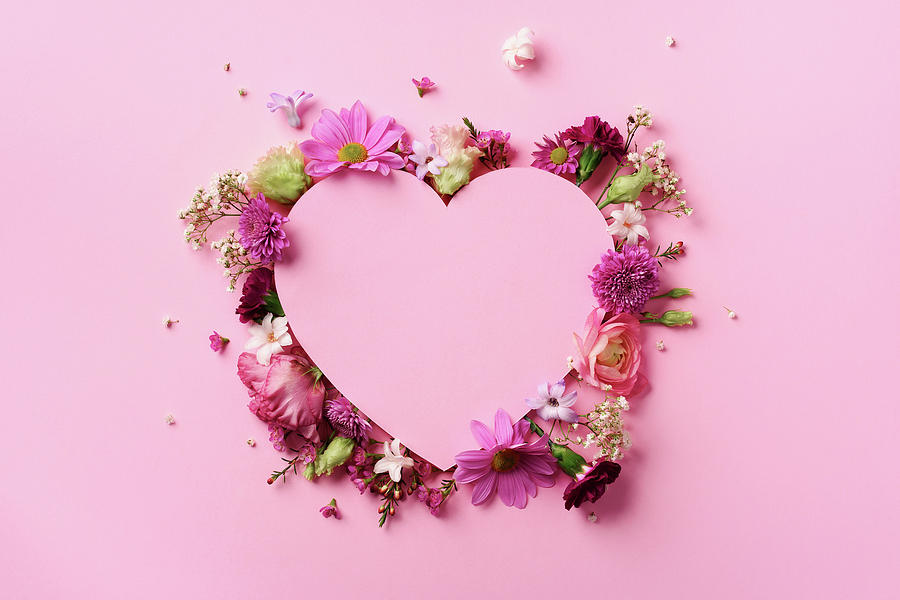 Creative layout with pink flowers, paper heart over punchy pastel background.  Top view, flat lay. Spring, summer or garden concept. Present for Woman day  Photograph by Yuliia Chyzhevska - Pixels