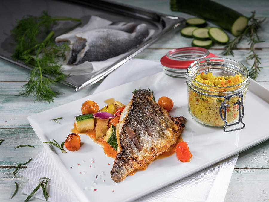 Crispy Fried Bream Filet With Tomatoes, Vegetables, And Couscous Photograph by Niklas Thiemann