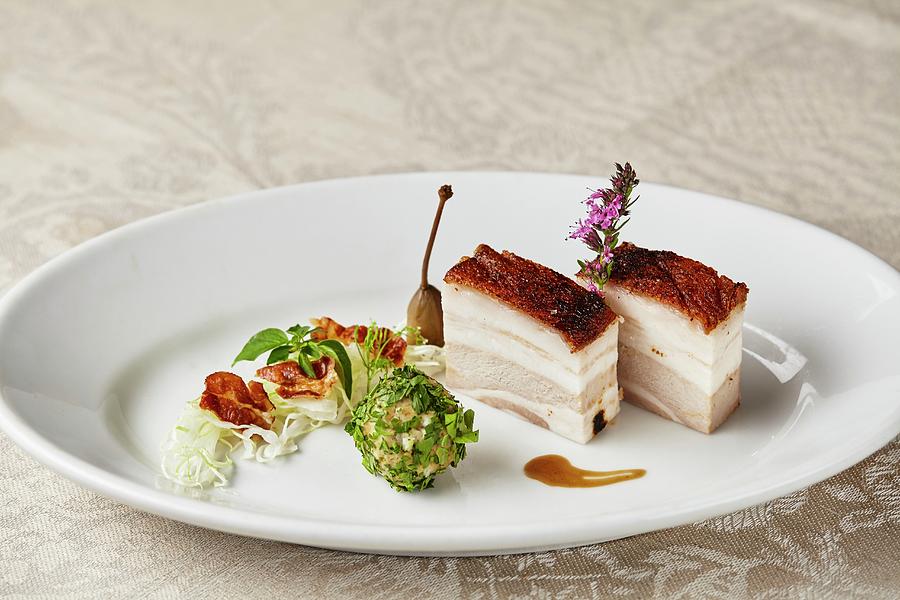Crispy Pork Belly With Loveage Dumplings And Warm Bacon And Cabbage Salad Photograph by Herbert Lehmann