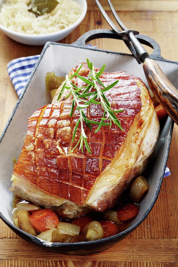 Crispy Roast Pork With Vegetables And Sauerkraut Photograph by Bjrn Llf