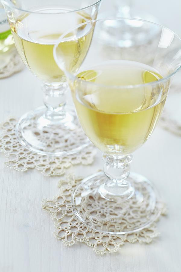 Crocheted Doilies Used As Coasters For Wine Glasses Photograph by Franziska Taube