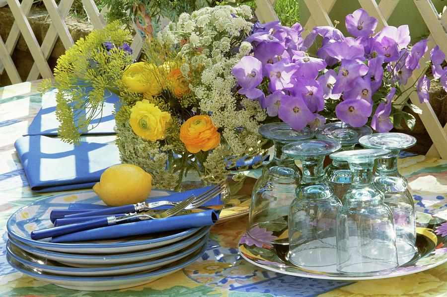 Crockery, Cutlery And Flowers On Table Out Of Doors Photograph by Linda Burgess